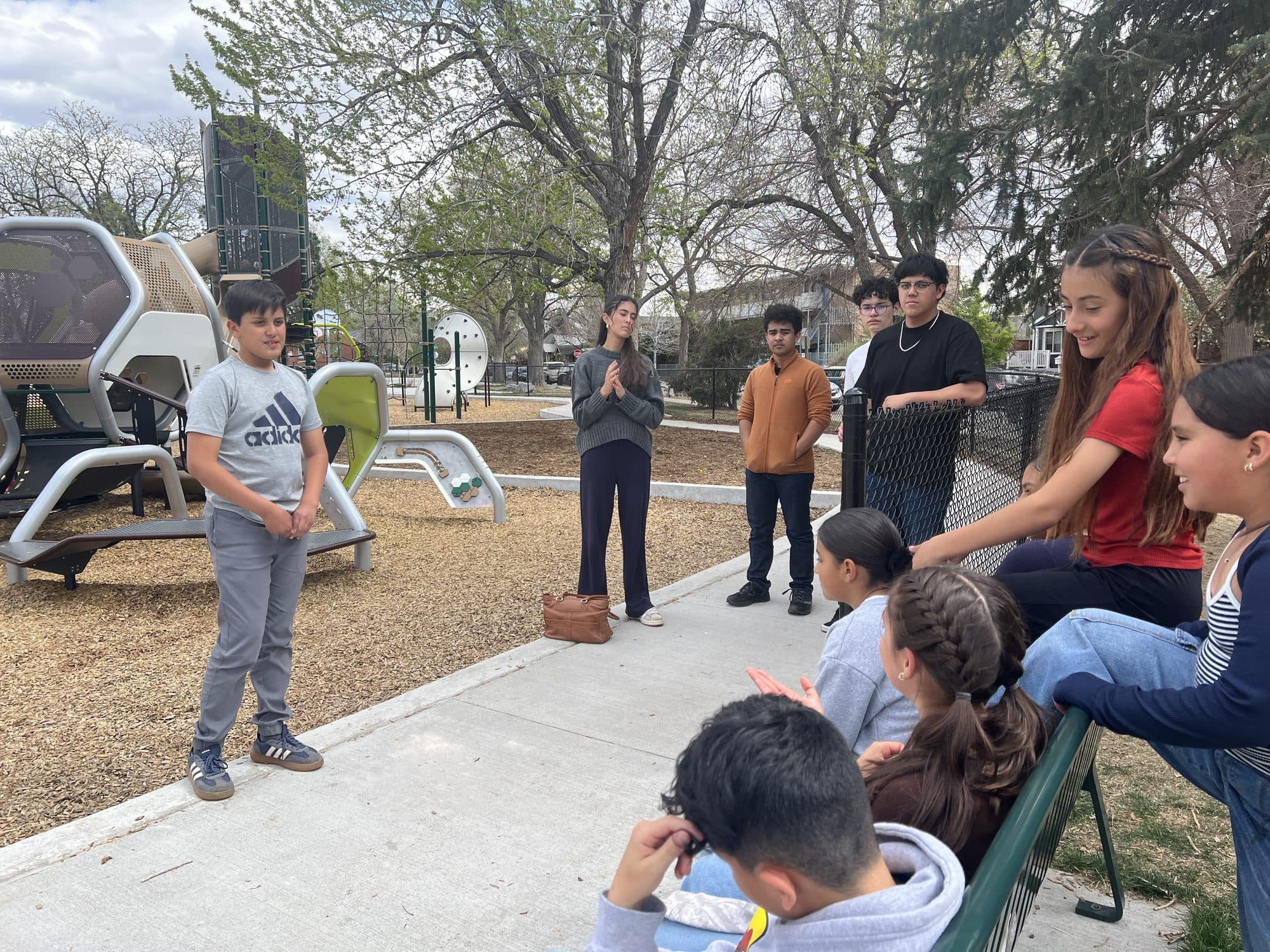 A student speaks to the group while classmates smile and listen at an SSDN workshop