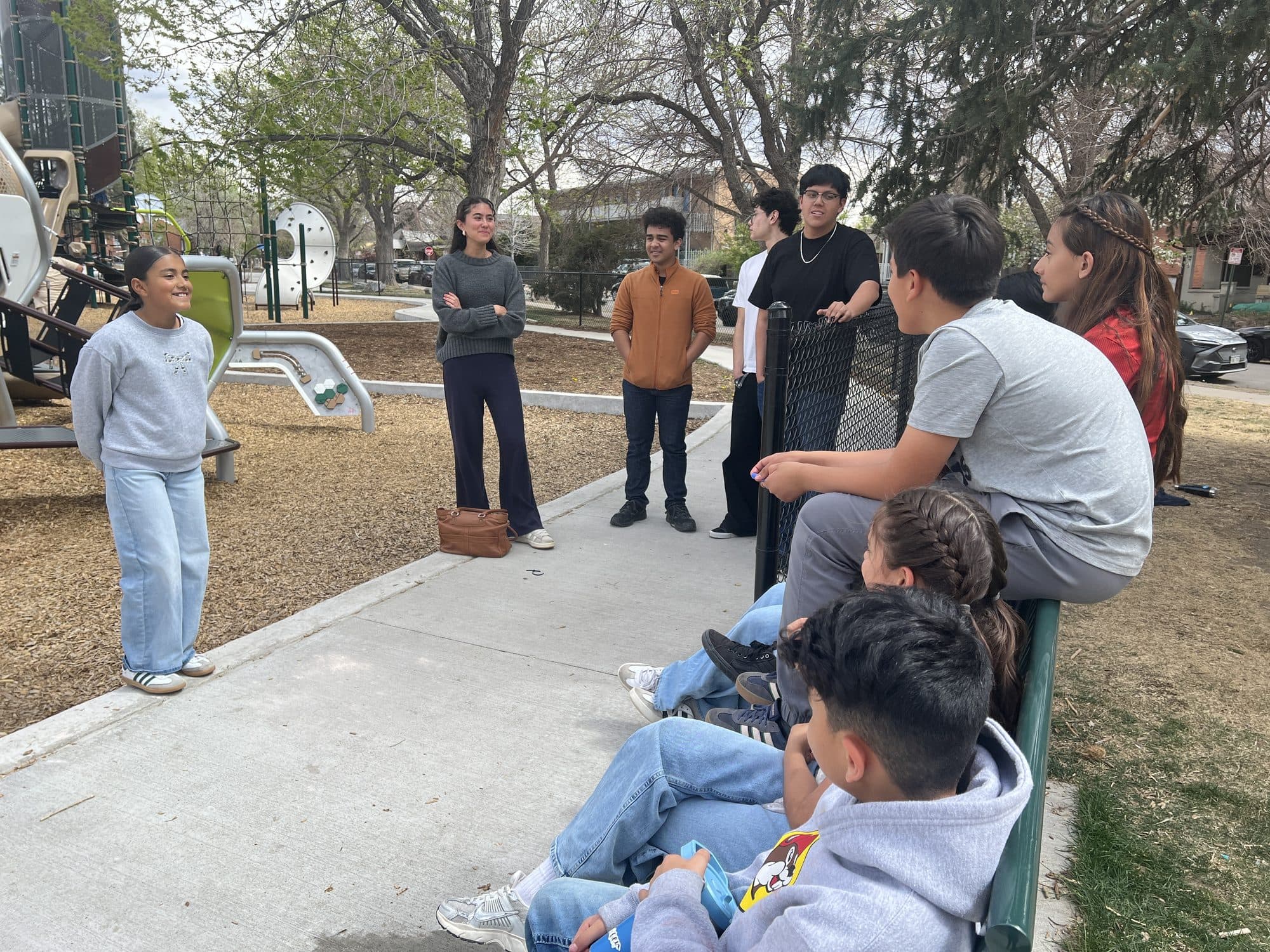 Young leader speaking confidently in front of a group during a workshop at the park