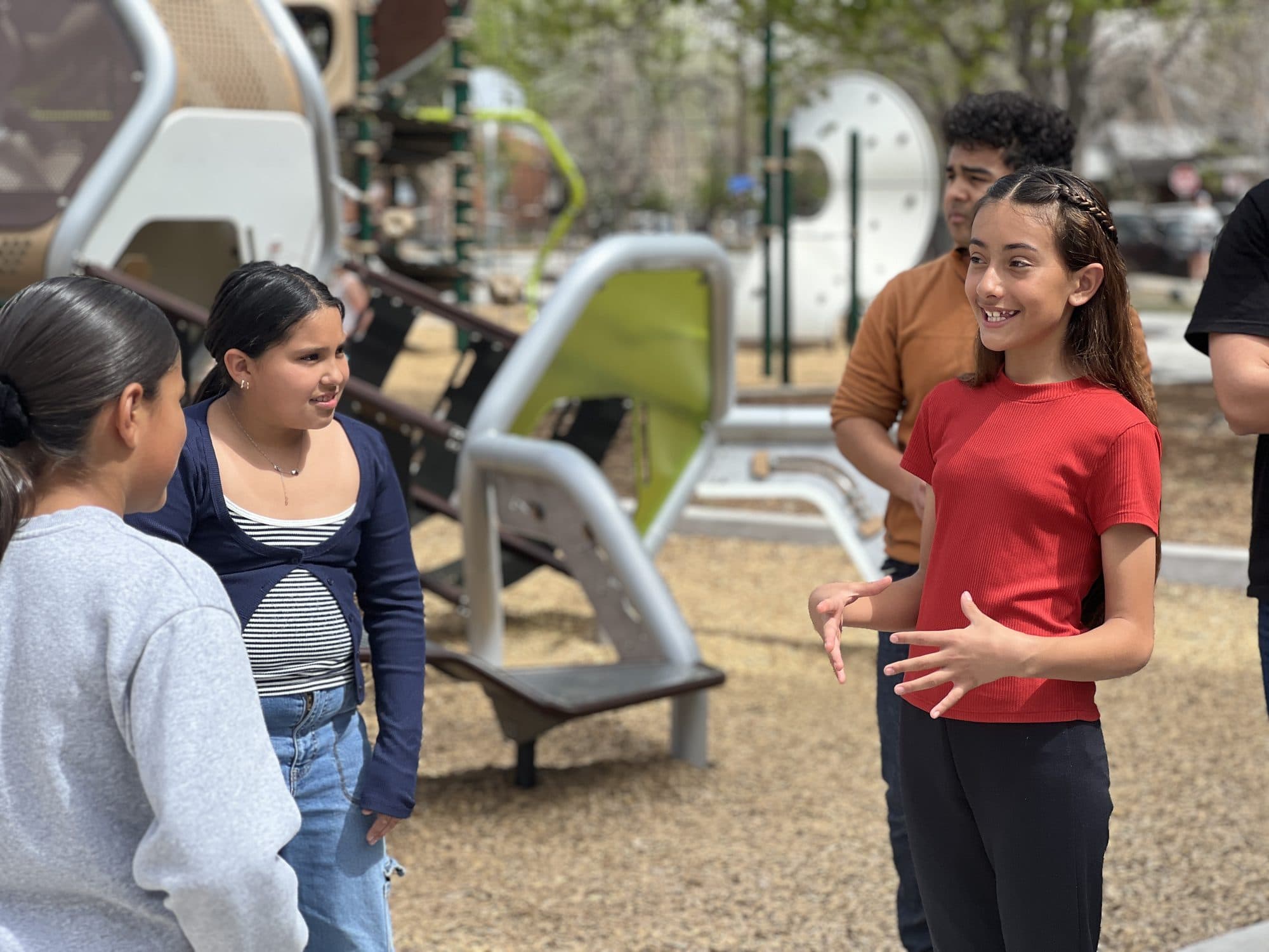 Student speaking with confidence and a smile in front of her group