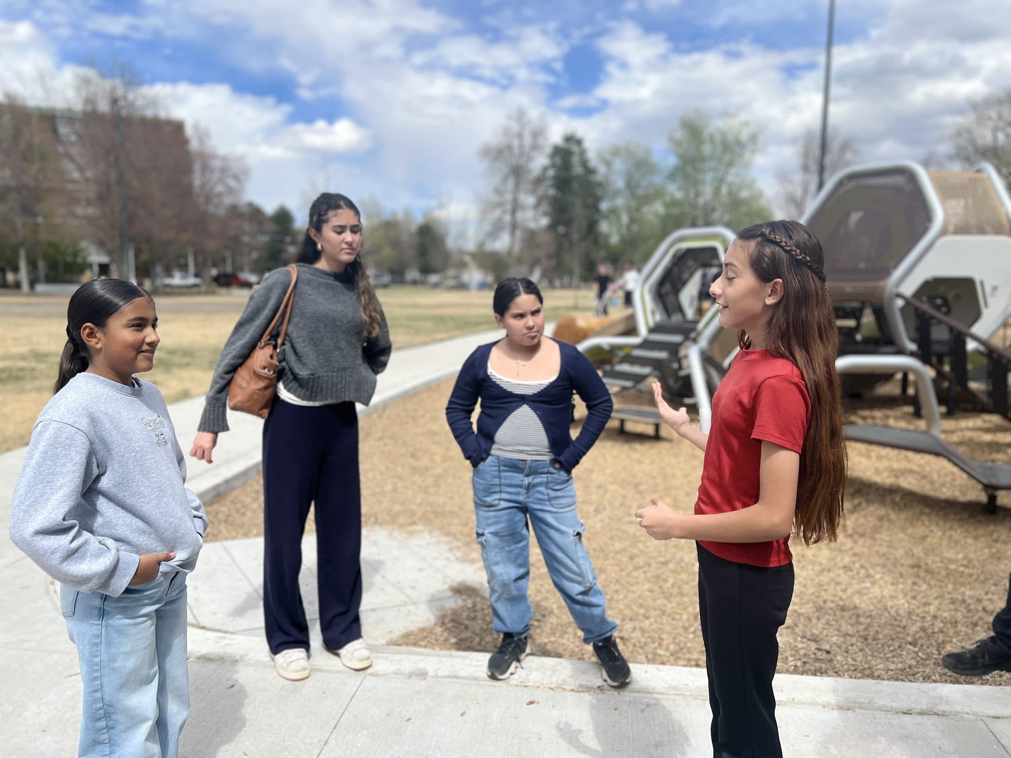 Group of youth smiling during an outdoor debate